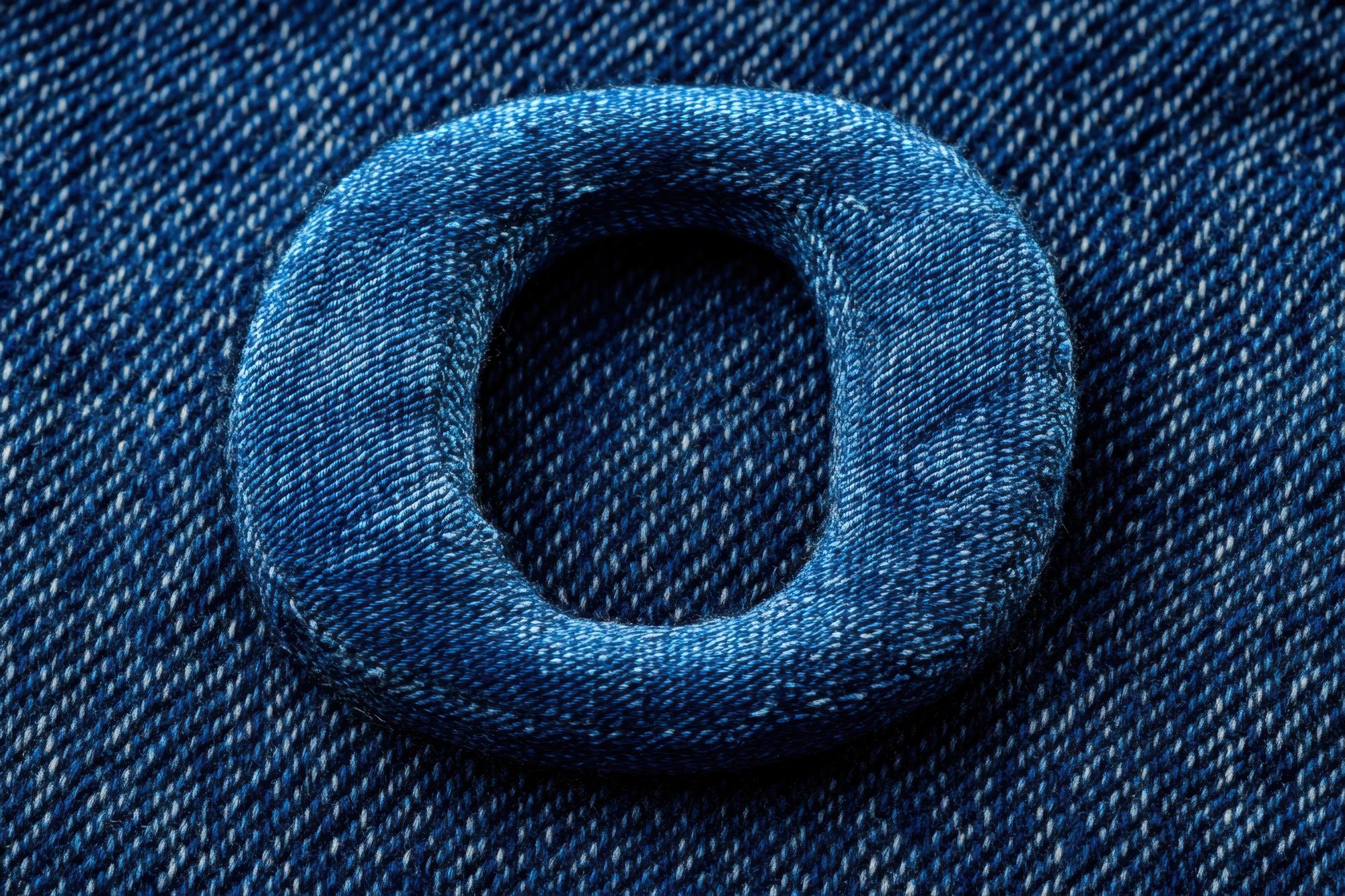 Close-up of embroidered initials on denim jacket